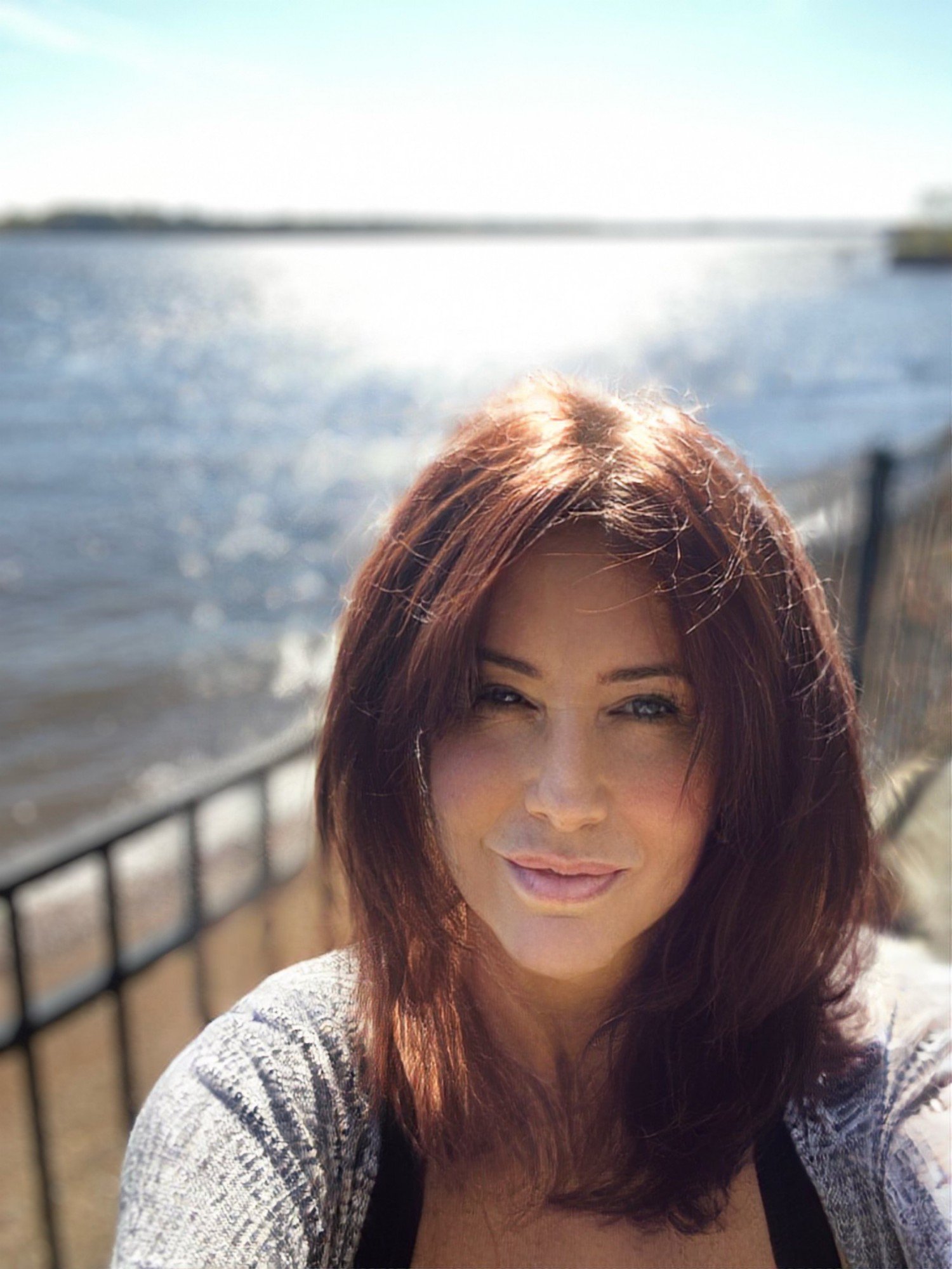 Gillian Parkinson F., founder of Trinket Trove and editor of The Trove, by the water in bright sun